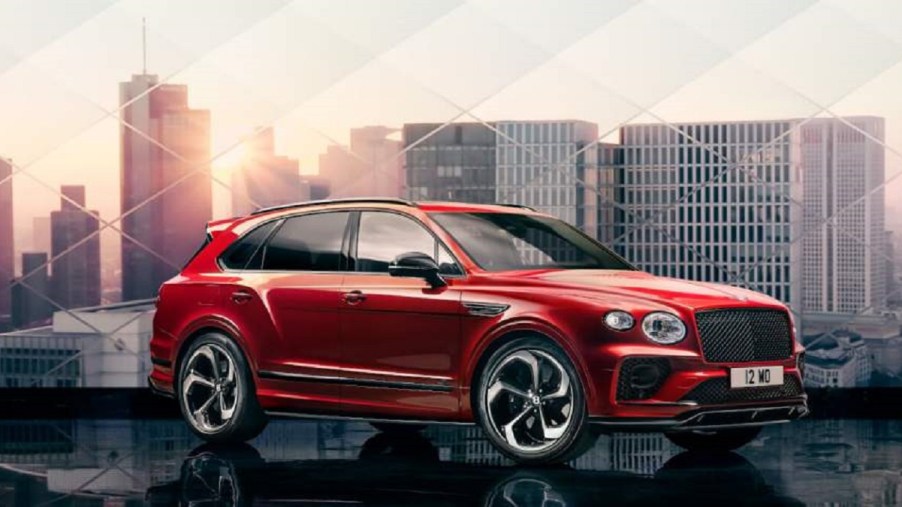 A red 2022 Bentley Bentayga against the backdrop of a city.