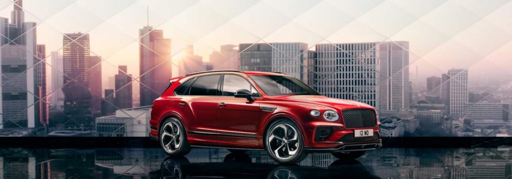 A red 2022 Bentley Bentayga against the backdrop of a city.