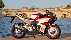The side view of a red-and-white 2022 Bimota KB4 on a dock