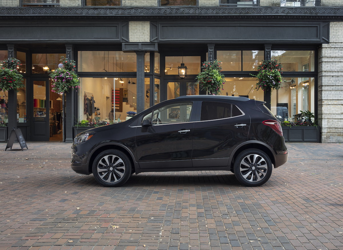 A black 2022 Buick Encore premium subcompact SUV parked outside a storefront
