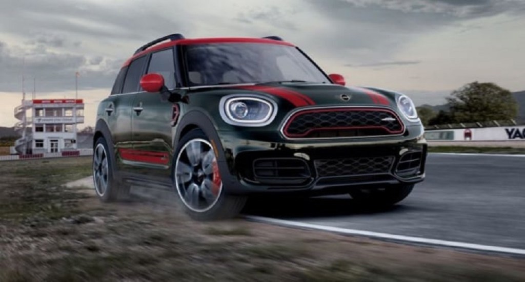 A black and red 2022 Mini Countryman driving down a city.