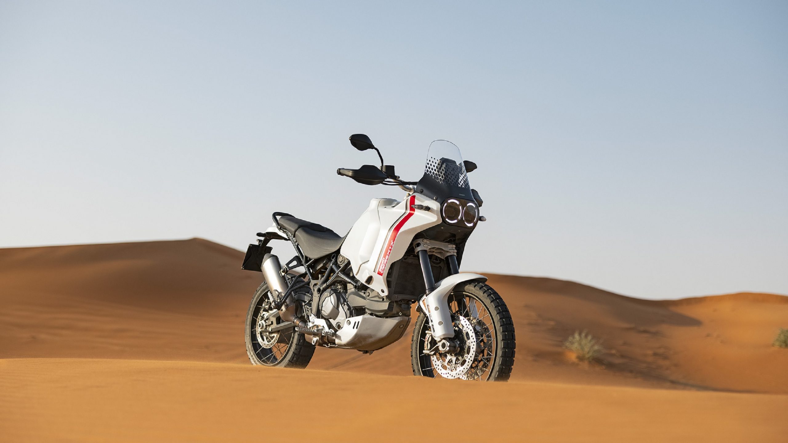 A white-and-red 2022 Ducati DesertX in the desert