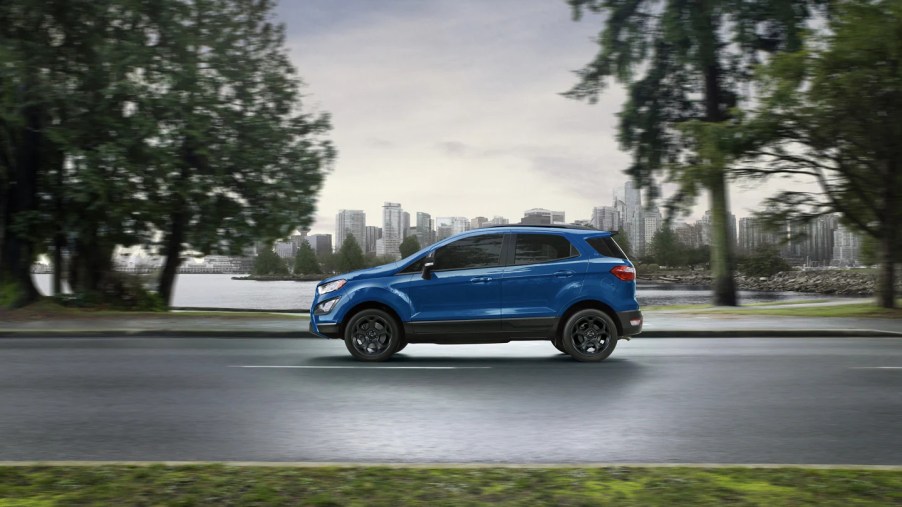 A blue 2022 Ford EcoSport driving on a road with trees in the background, this SUV died in 2021.