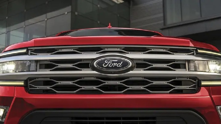 The front grille of a red 2022 Ford Expedition Max.