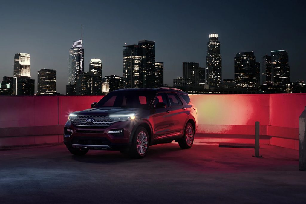 2022 Ford Explorer King Ranch SUV parked with a city background at night with the lights on, is it really worth $54K?