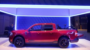 A red 2022 Ford Maverick pickup truck is on display.