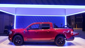 A red 2022 Ford Maverick pickup truck is on display.