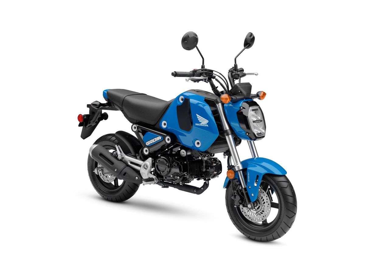 A 2022 Honda Grom in Candy Blue in front of a white background.