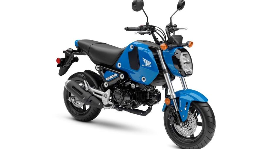 A 2022 Honda Grom in Candy Blue in front of a white background.