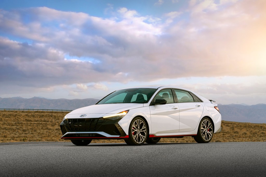 A white 2022 Hyundai Elantra N shot from the front 3/4 at sunset