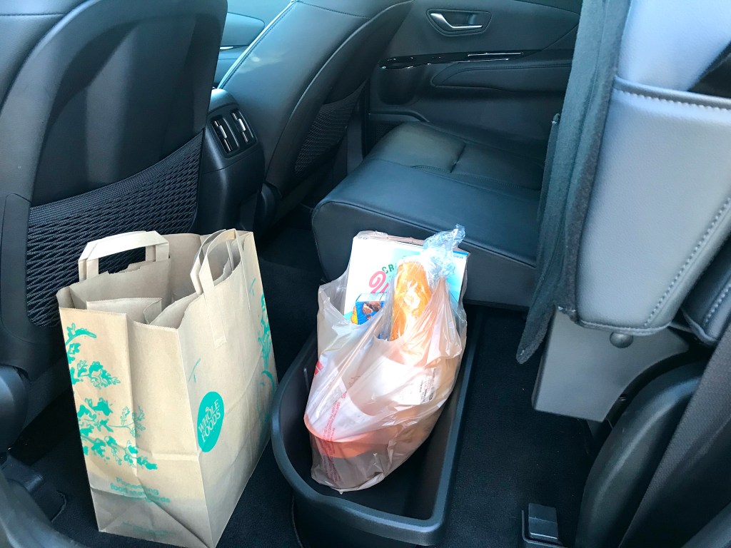 The 2022 Hyundai Santa Cruz with a groceries in the rear seat storage area.