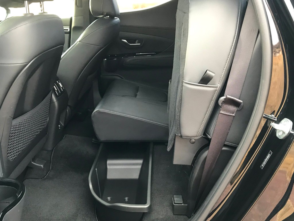 The rear seats in the 2022 Hyundai Santa Cruz folded up to reveal a storage cubby.
