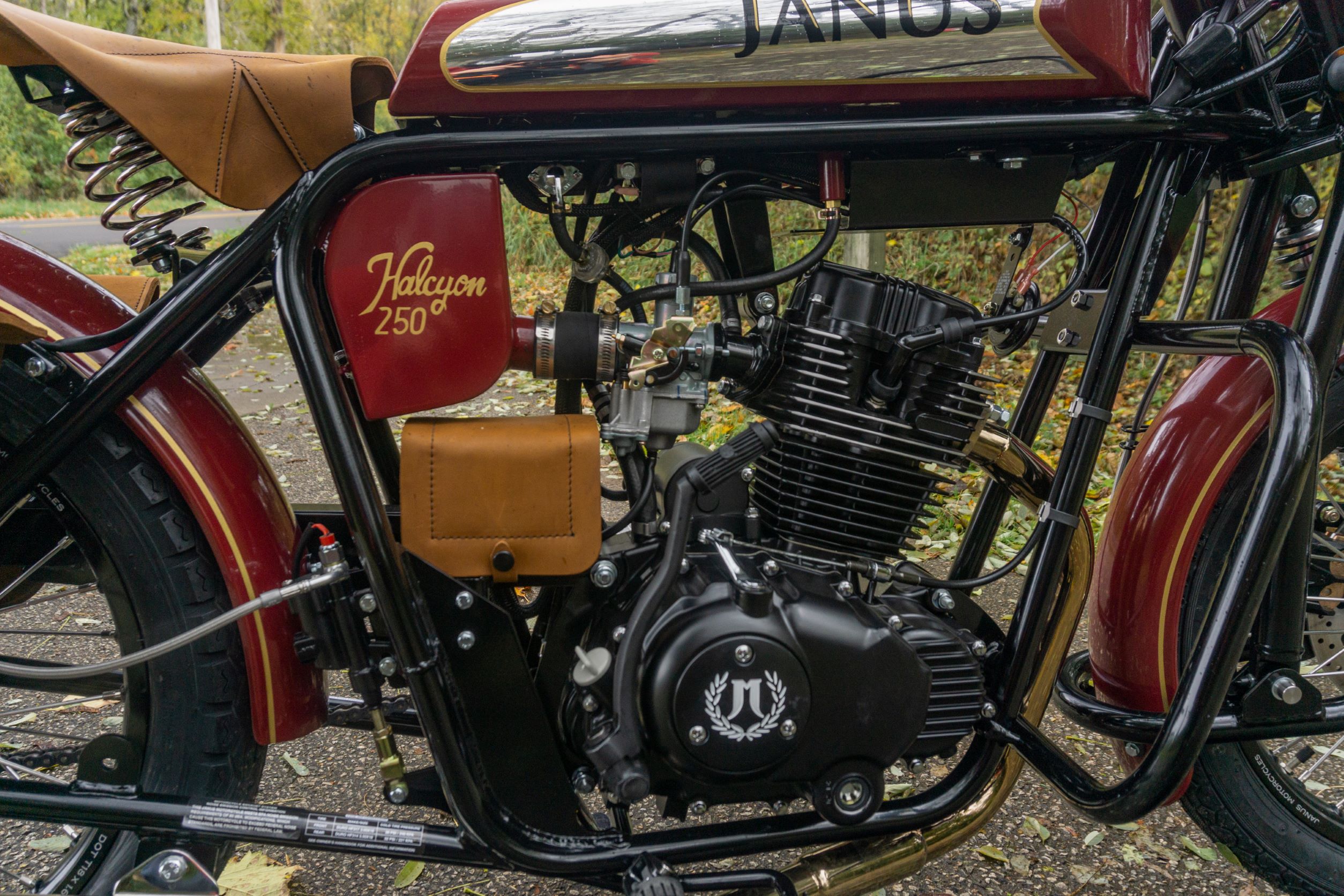 A side view of a red-and-chrome 2022 Janus Halcyon 250's engine