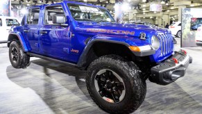 A blue Jeep Gladiator is on display.