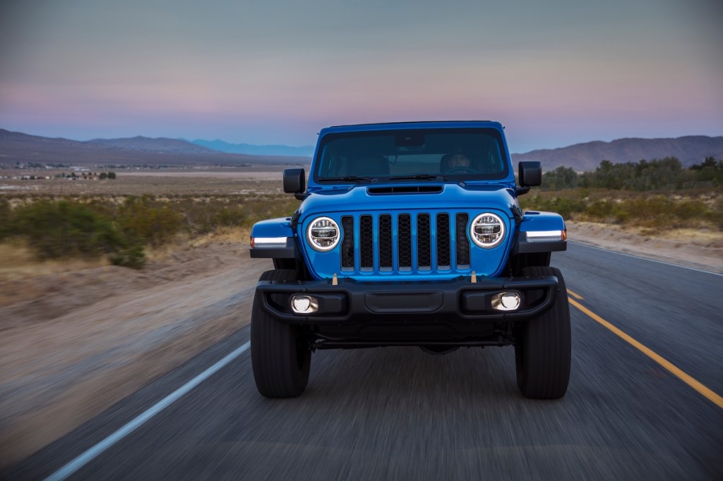 Front view of a blue 2022 Jeep Wrangler Rubicon 392 traveling on a desert road