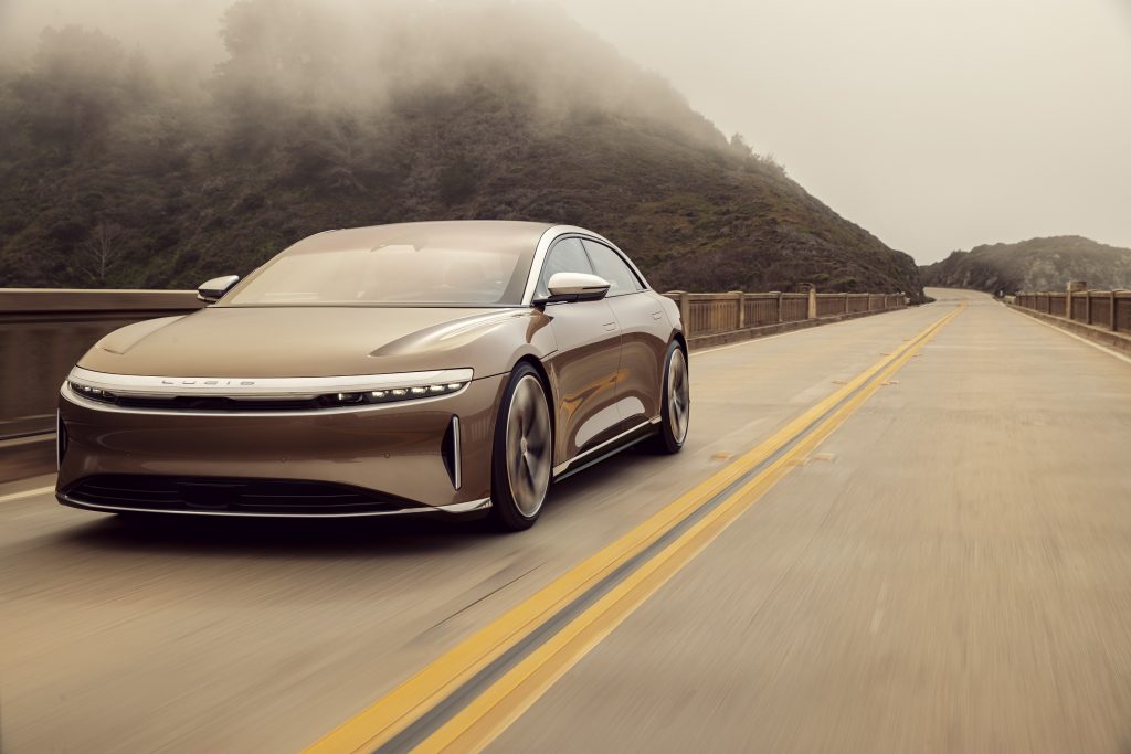 A gold 2022 Lucid Air Dream Edition P drives down the road