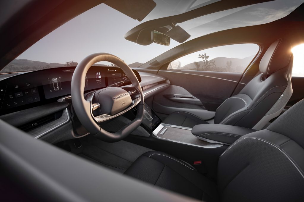 The gray-cloth-and-leather front seats and dashboard of a 2022 Lucid Air