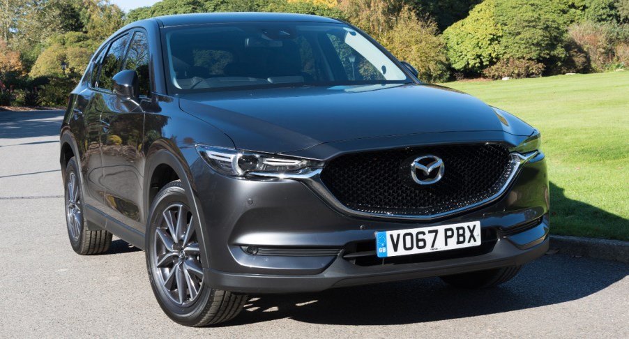 A black 2022 Mazda CX-5 is parked on the road.