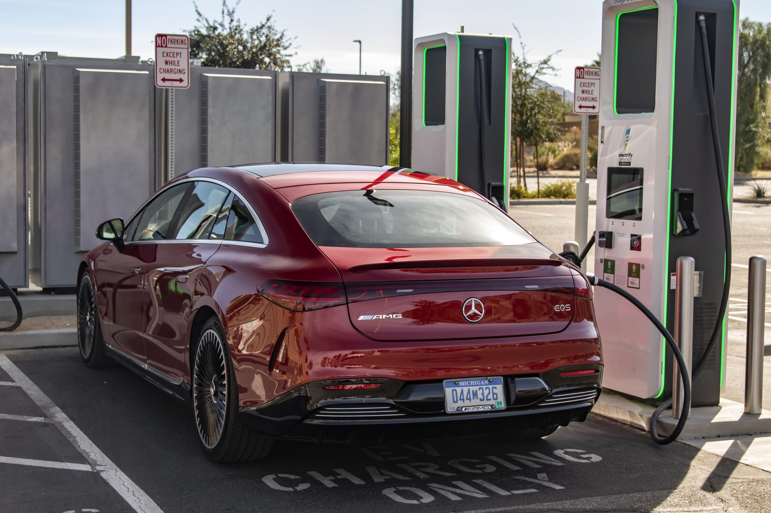 A red Mercedes-Benz EQS EV charging