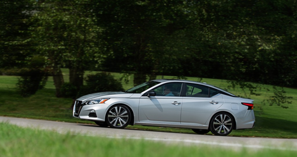 a silver 2022 Nissan Altima drives down the road