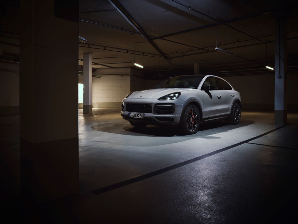 A white 2020 Porsche Cayenne in a parking garage environment.