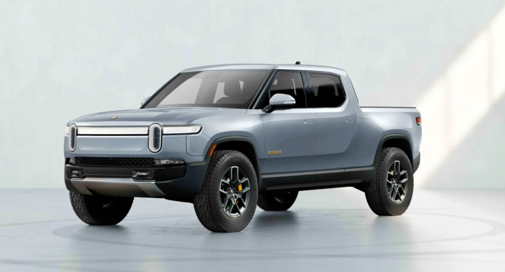 An ice blue 2022 Rivian R1T against a gray background.