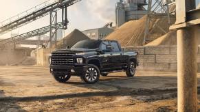 A black 2022 Chevy Silverado 2500 HD heavy-duty pickup truck parked on a construction site.