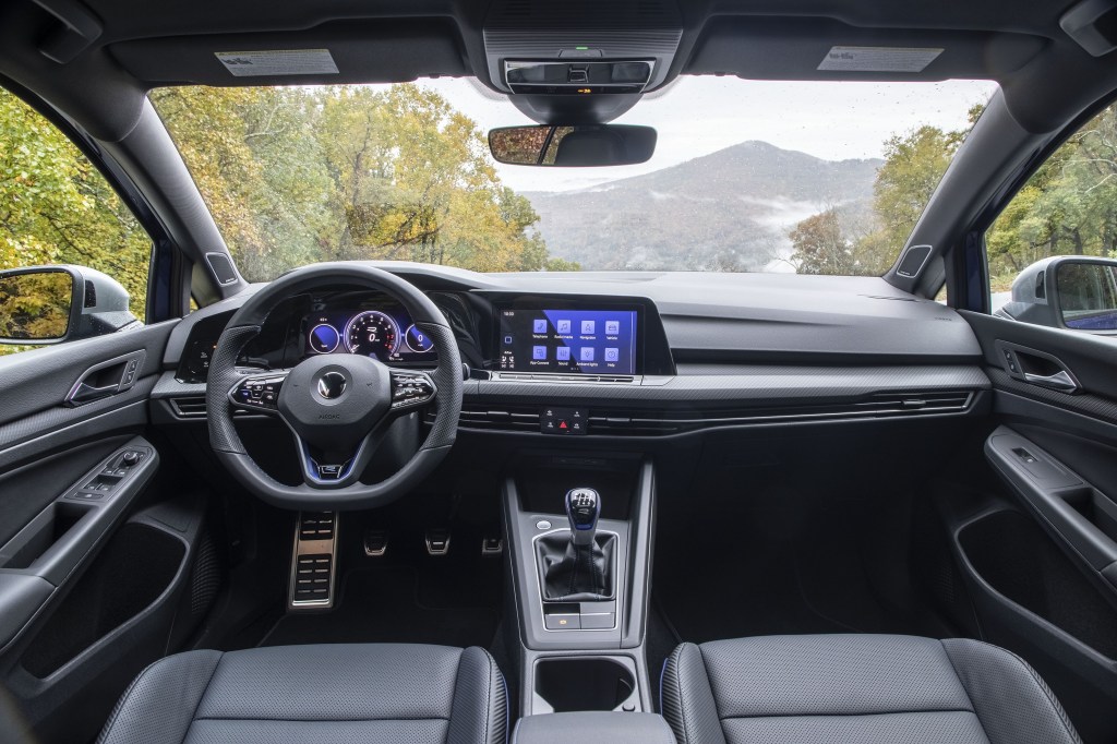 The black-leather-upholstered front seats and dashboard of a 2022 Volkswagen Golf R