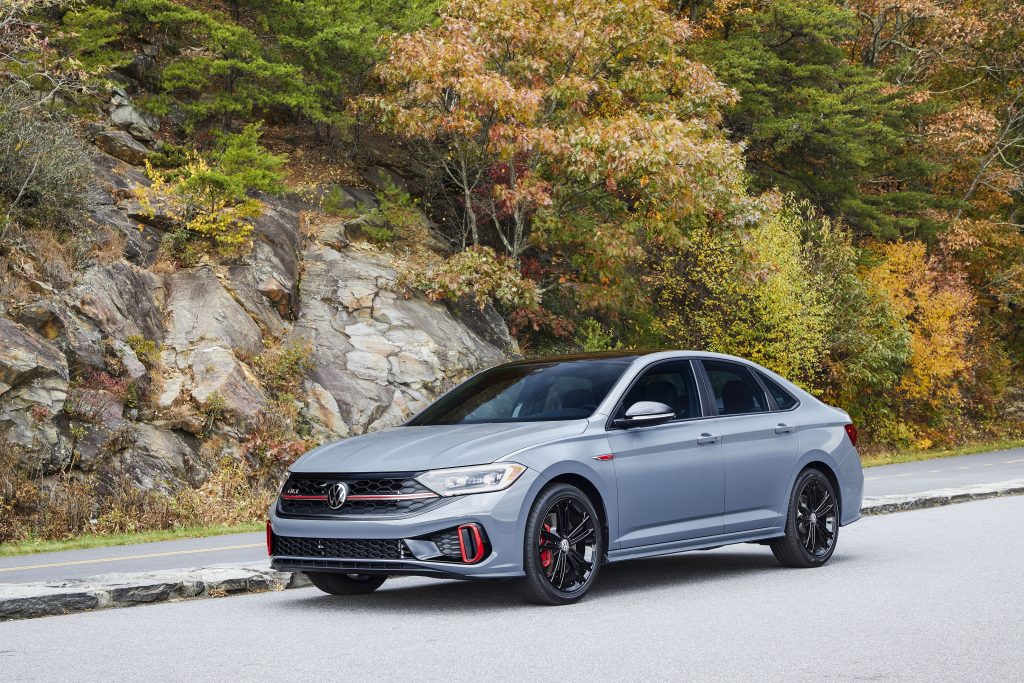 A gray-black-and-red 2022 Volkswagen Jetta GLI on a cliffside road