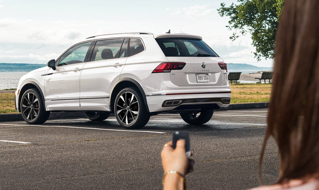 A person using a key to unlock their 2022 Volkswagen Tiguan in white, which has new features, price, and specs for the new year. 