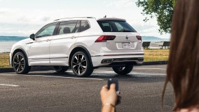 A person using a key to unlock their 2022 Volkswagen Tiguan in white, which has new featues, price, and specs for the new year.
