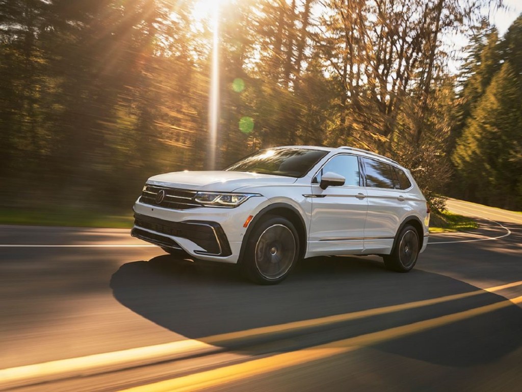 A white 2022 Volkswagen Tiguan R-Line driving down a sunny road, what is the price and what features does it have?