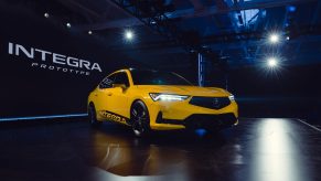 A yellow 2023 Acura Integra on stage at its debut in Los Angeles
