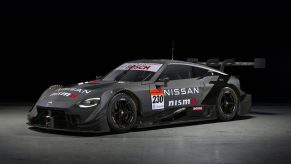 A black 2023 Nissan Z race car shot in a photo booth from the 3/4 angle