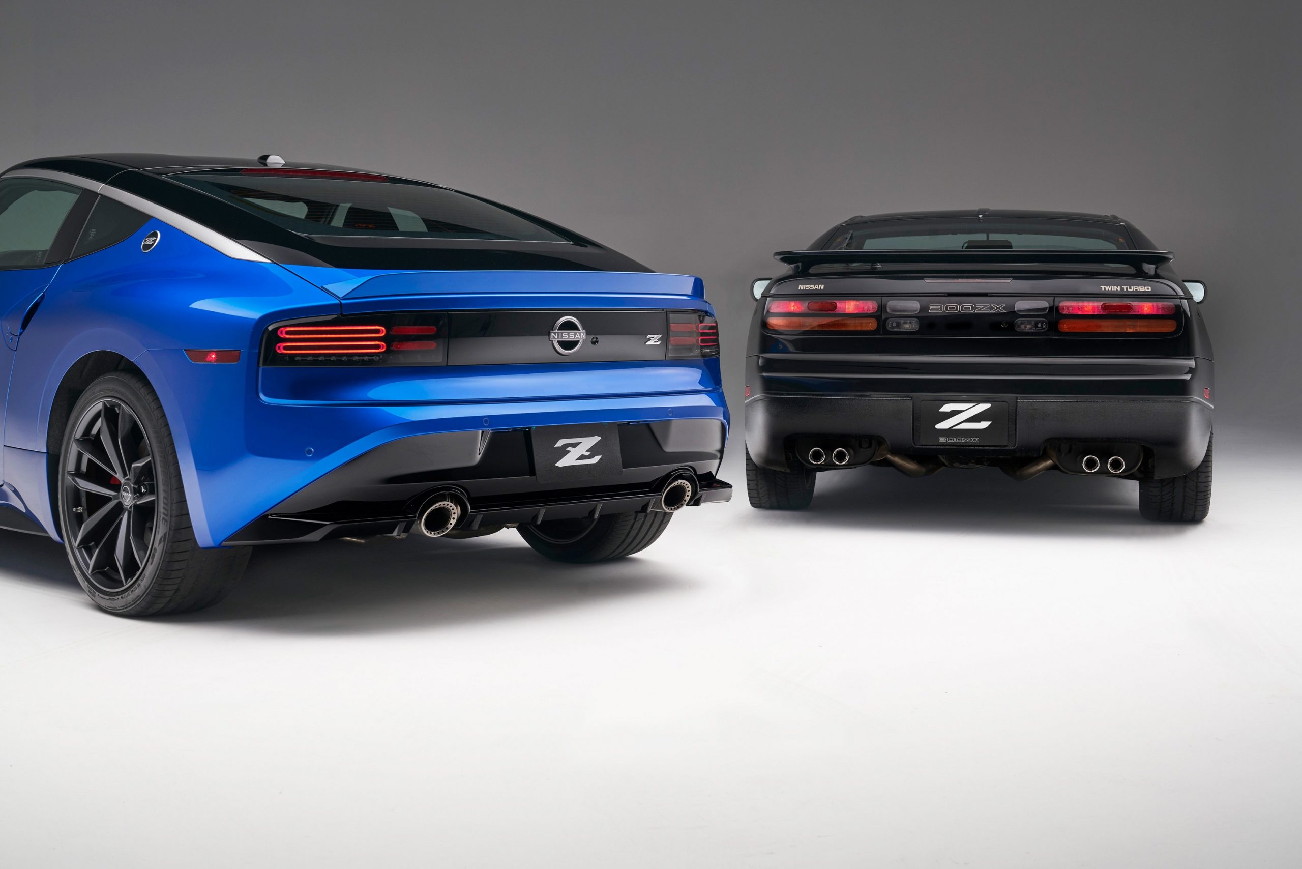 The rear of the Nissan 300ZX next to the 2023 Nissan Z in blue
