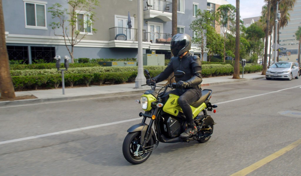 A rider riding on a 2022 Honda Navi on the street