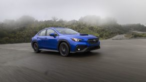 A Rally Blue 2022 Subaru WRX, which swayed Doug DeMuro's opinion, shot from the front 3/4 in the rain