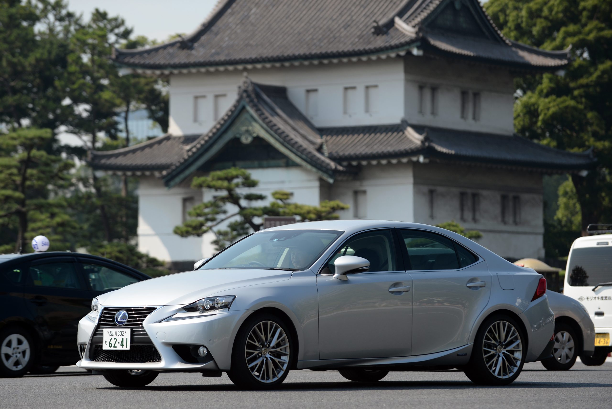 A silver Lexus IS luxury car shot from the front 3/4 in Japan