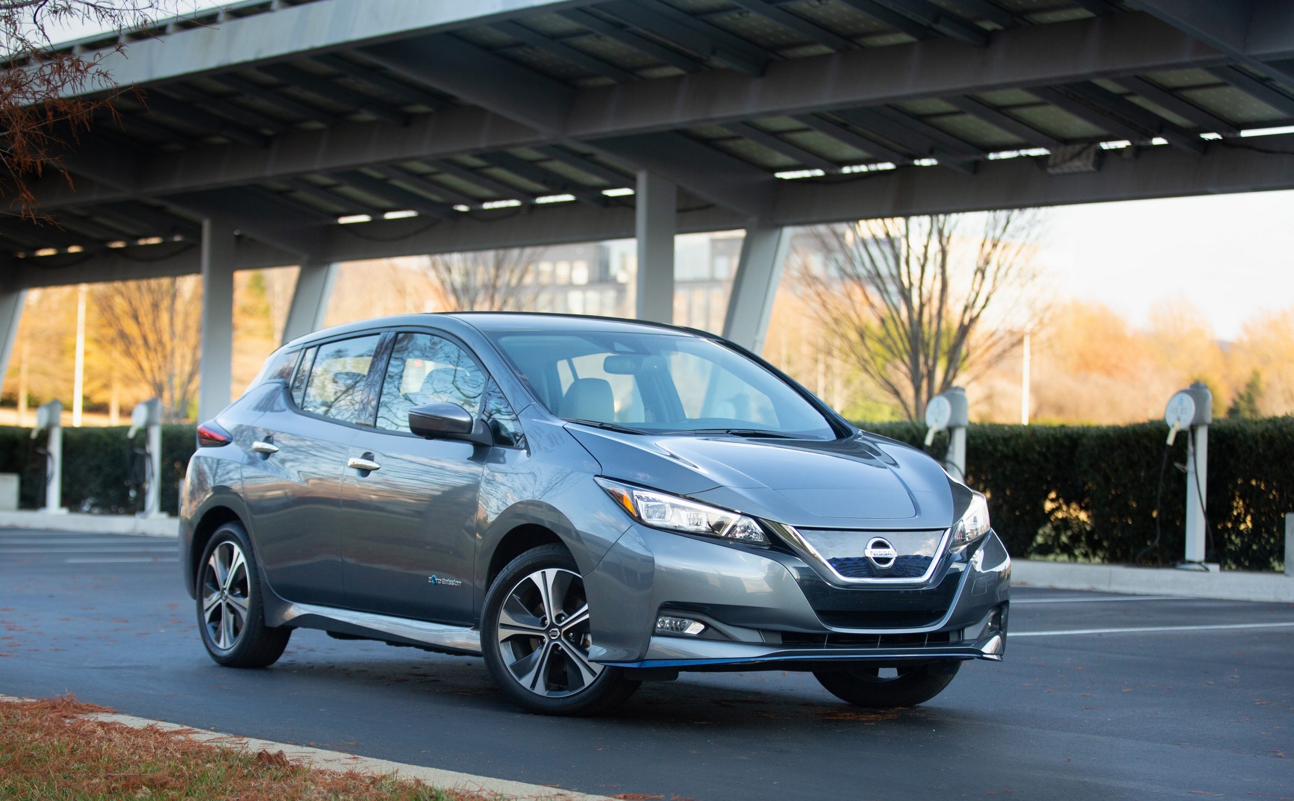 A 3/4 shot of a grey Nissan Leaf EV in a car park