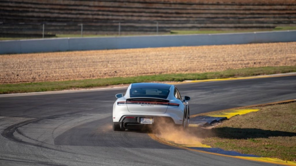 A fully loaded new 2022 Porsche Taycan Turbo S driving on a racetrack