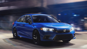 Aegean Blue Metallic 2022 Honda Civic driving on a street at night