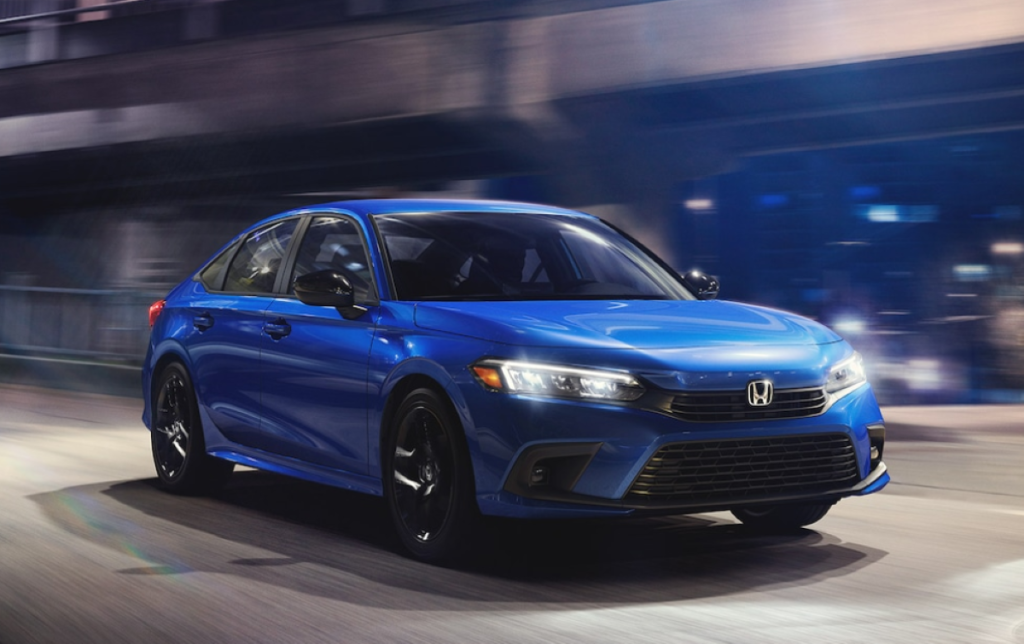 Aegean Blue Metallic 2022 Honda Civic driving on a street at night