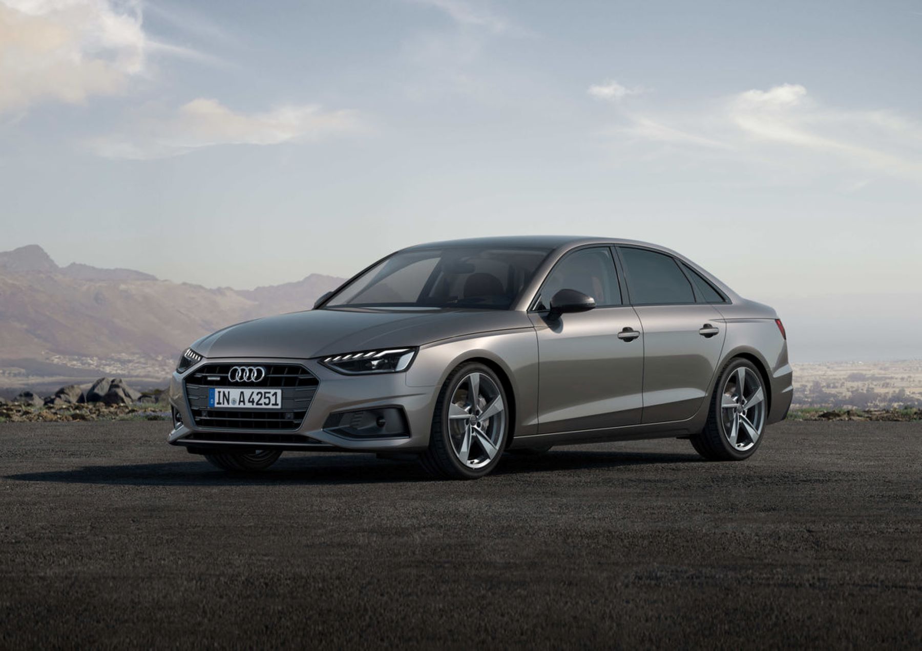 The Audi A4 Sedan luxury executive car parked on a dirt lot with mountains and fog in the background