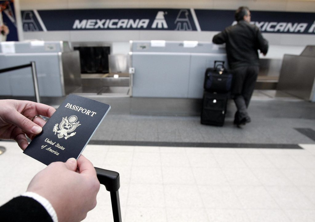 This passenger is waiting in line for holiday travel  | JEFF HAYNES/AFP via Getty Images