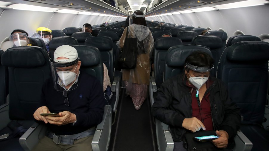 Airplane passengers wearing masks for holiday travel | Raul Sifuentes/Getty Images
