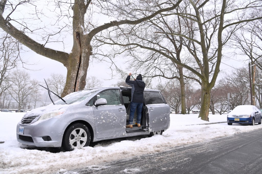someone working on their car before winter driving