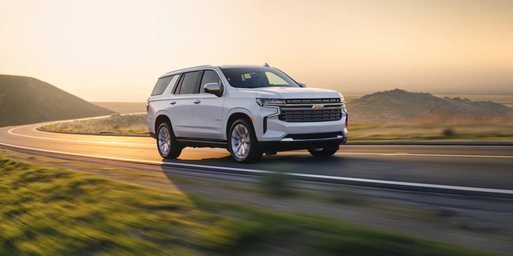 A white 2022 Chevy Tahoe driving on a road, it got a new transmission along with its sibling, the 2022 Chevy Suburban.