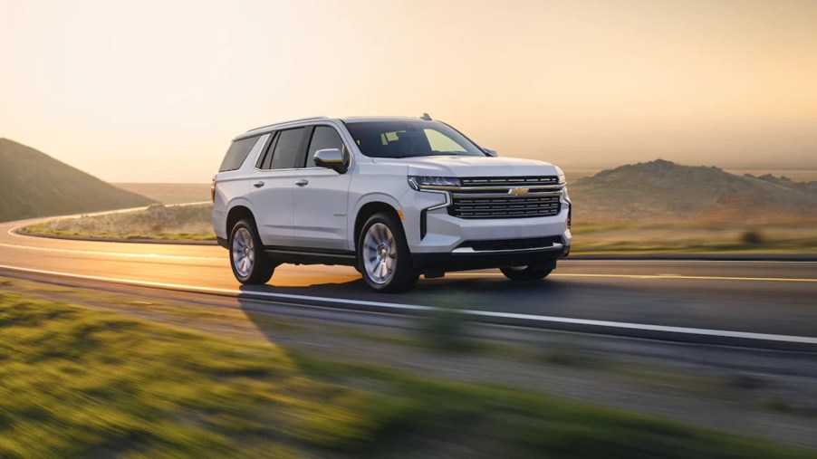 A white 2022 Chevy Tahoe driving on a road, it got a new transmission along with its sibling, the 2022 Chevy Suburban.