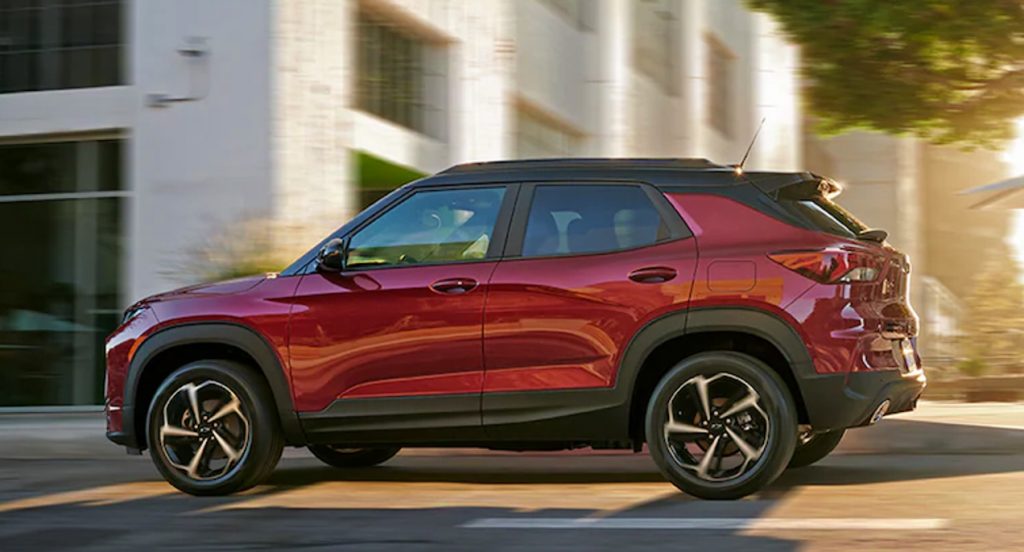A red 2022 Chevy Trailblazer is driving on the road. 