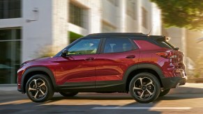 A red 2022 Chevy Trailblazer is driving on the road.